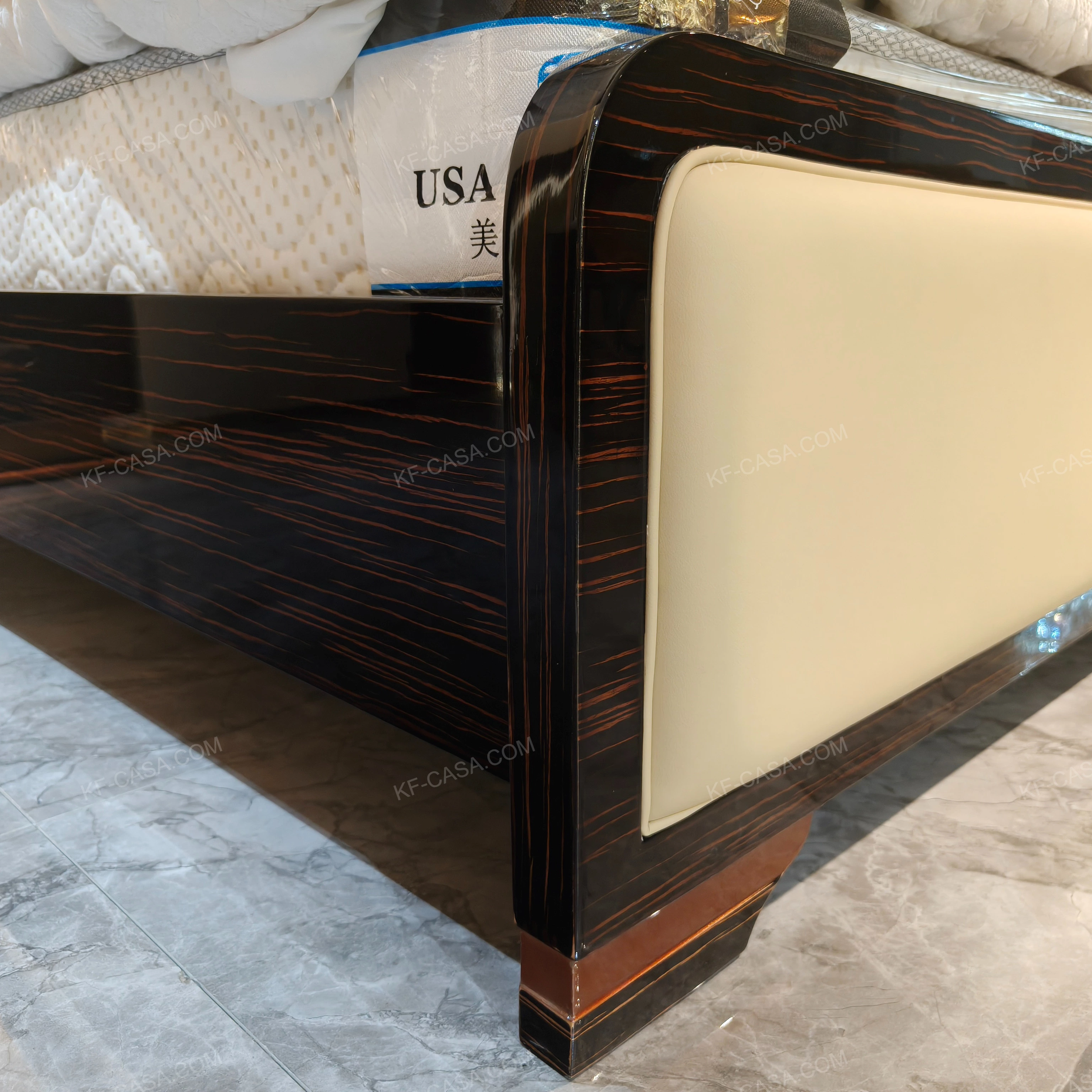 Cream Leather Upholstered Bed with Dark Natural Wood Veneer Trim, Embossed Brand Emblem & Copper-Accented Hardware